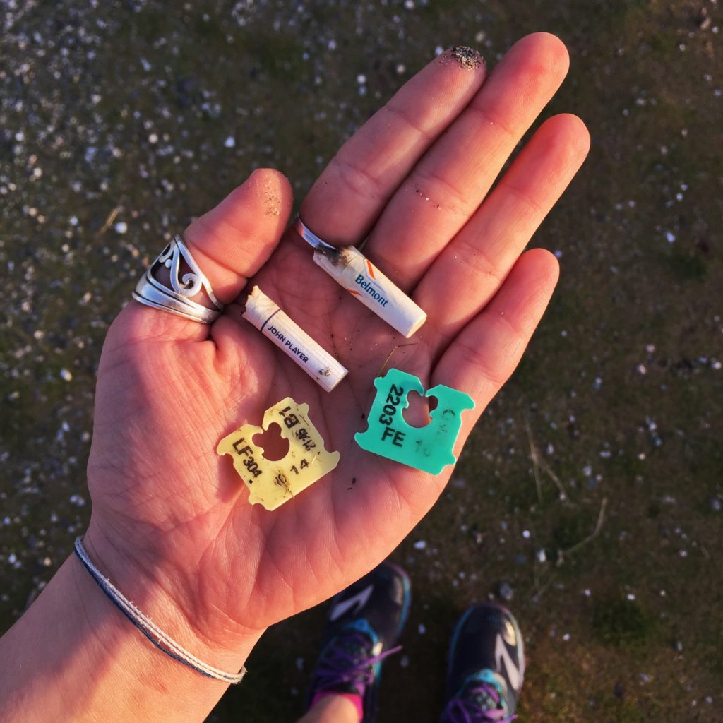 a handful of cigarette butt and plastic bag tie trash found on Crescent Beach in Surrey, BC.