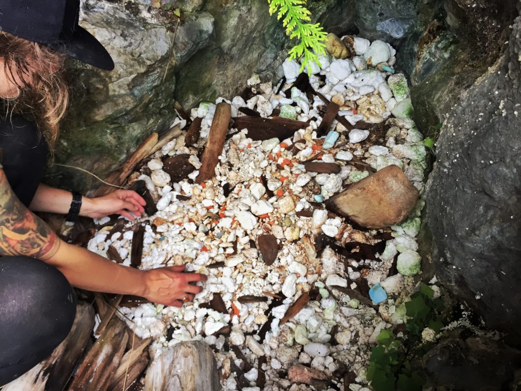 Ocean Legacy Foundation crew member digging through a pit of polystyrene foam on Texada Island, British Columbia, Canada