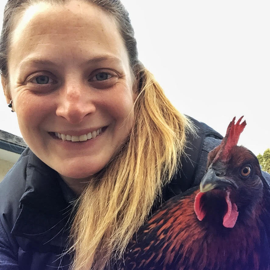 Ryan poses with one of her chickens, Miss Independent, both smiling!