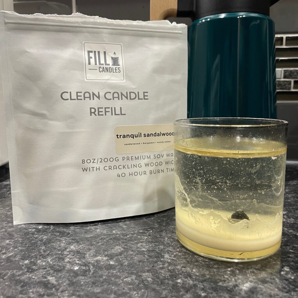 A "Clean Candle Refill" kit from FILL Candles, with an old, glass candle jar being cleaned of its old wax.